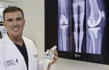 Dr. Buechel presenting post-operative x-rays of a patient after total knee replacement