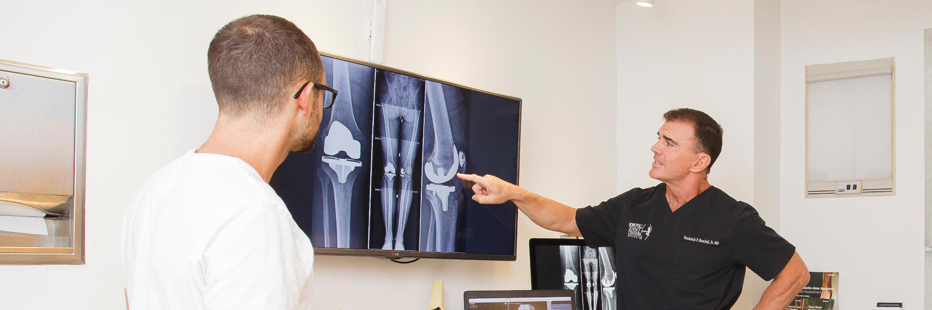 Dr. Buechel reviewing post-operative x-rays of his knee replacement patient.