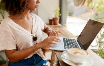 A woman with laptop during an online consultation.