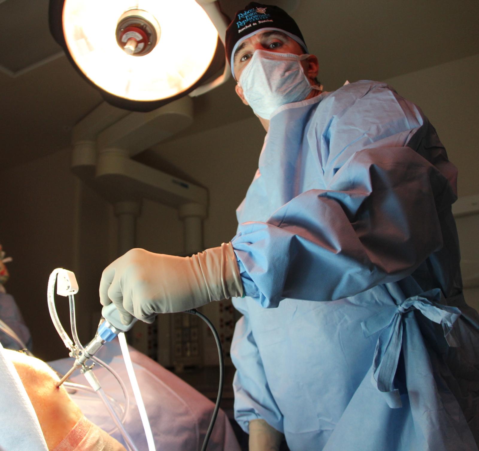 Dr. Buechel Performing knee arthroscopic surgery